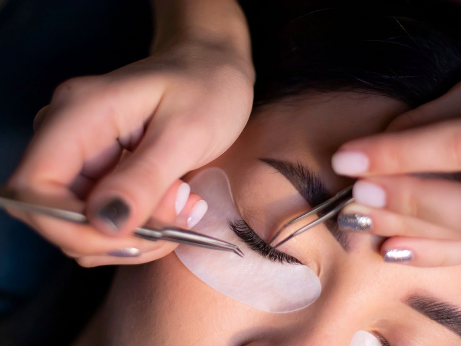A lash artist applying extensions one lash at a time