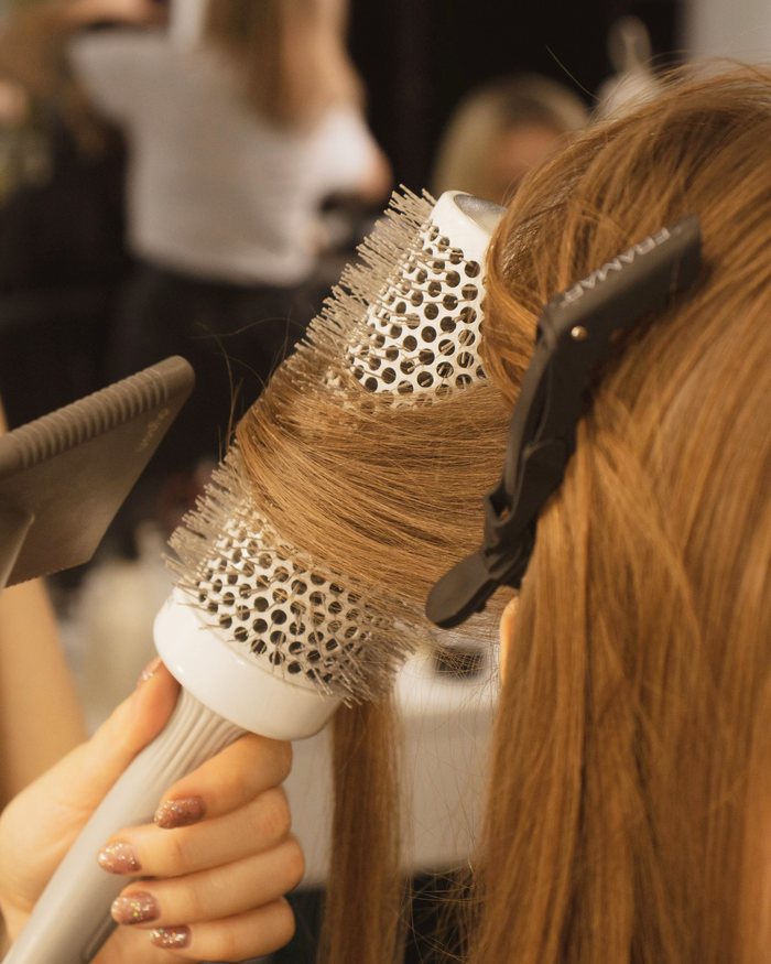 A round brush blow-dry being finished