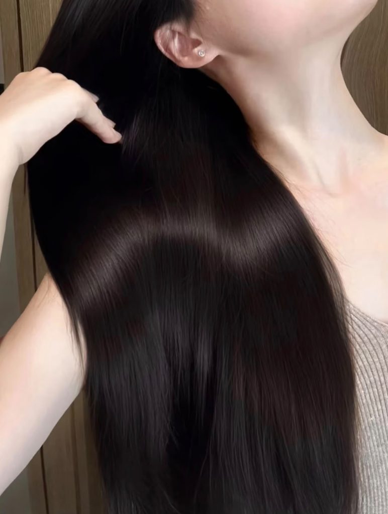 Long, glossy dark hair after a smoothing treatment