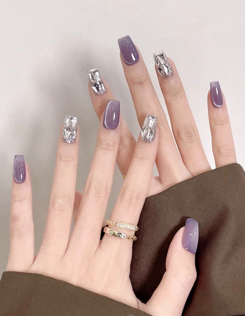 Shimmering lavender cat-eye nails with crystal-studded accent nails