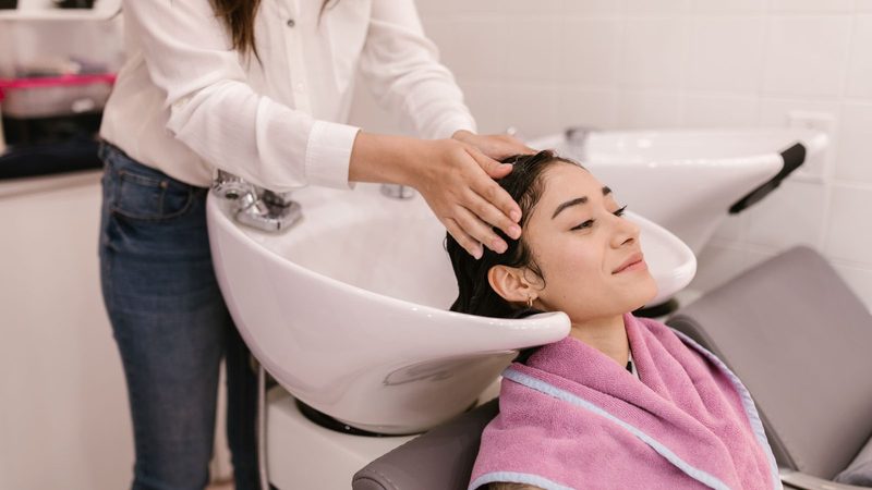 A client relaxing at the basin while her hair is washed