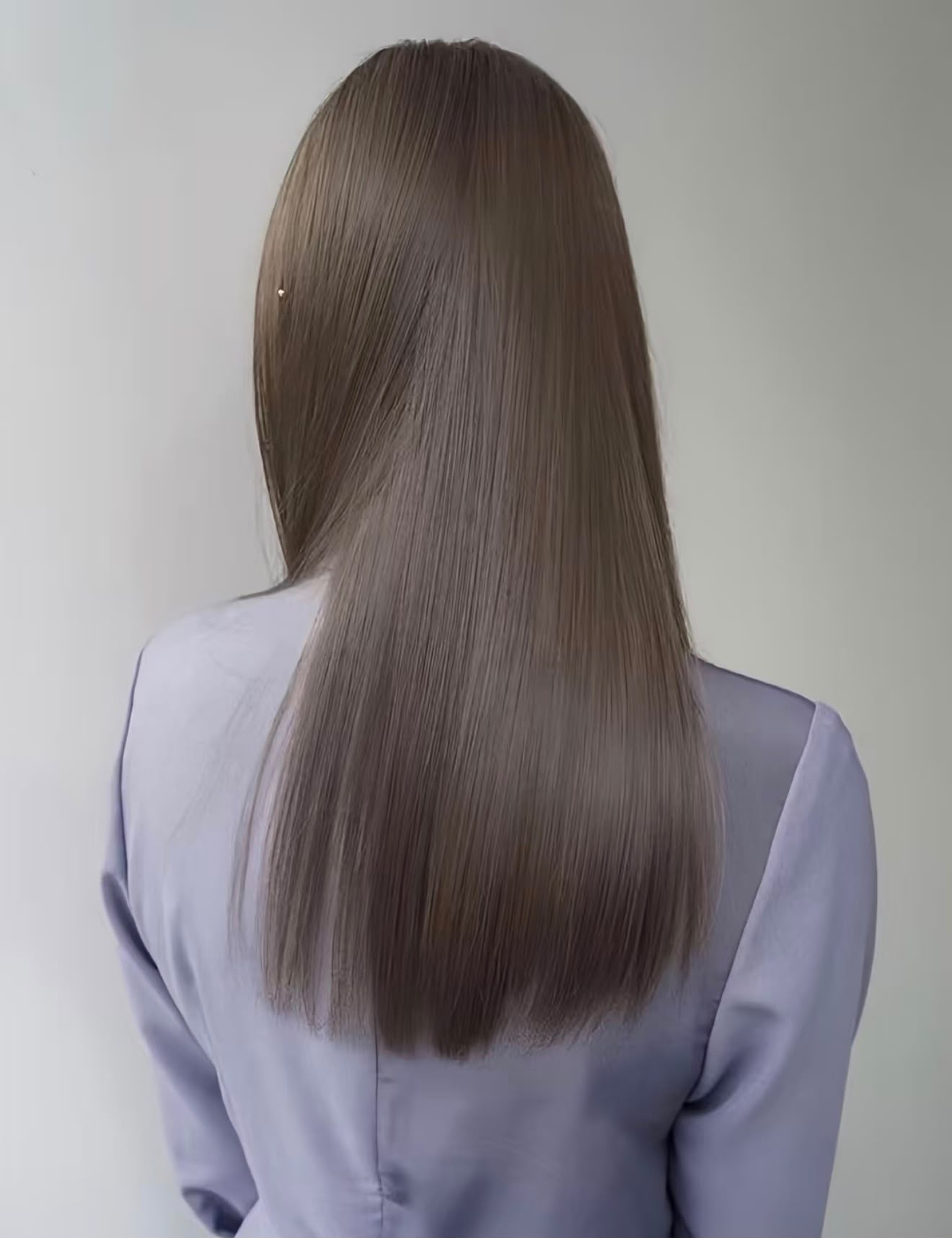 Long, sleek straight hair in a soft ash-brown tone, seen from behind