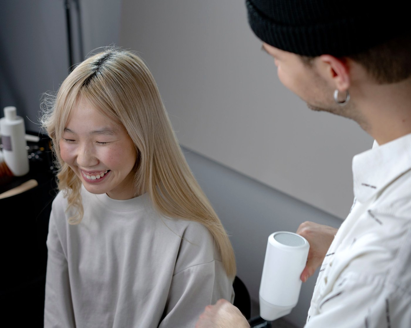 A client with long, freshly finished hair at the styling chair